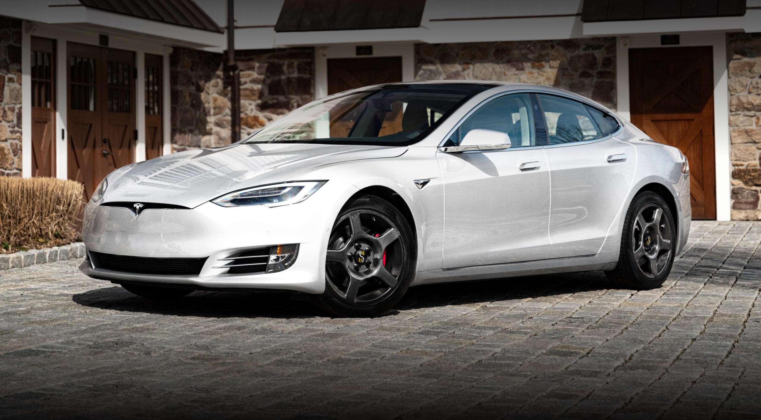 a white Tesla with carbon fiber wheels