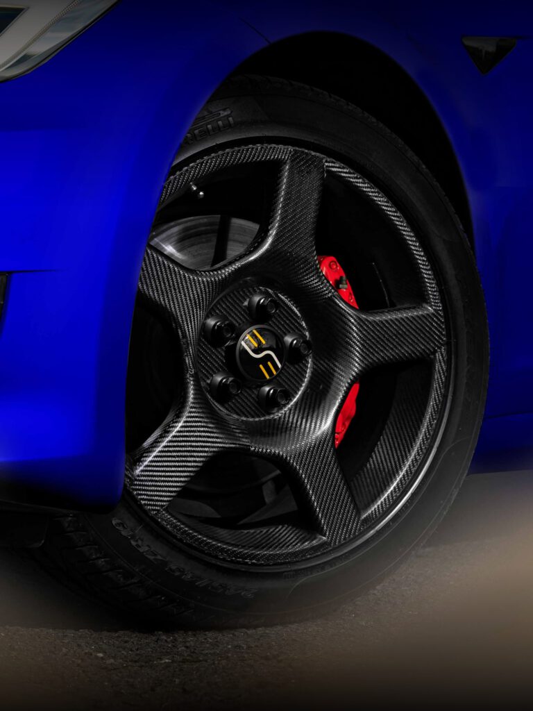 a blue car with a carbon fiber wheel