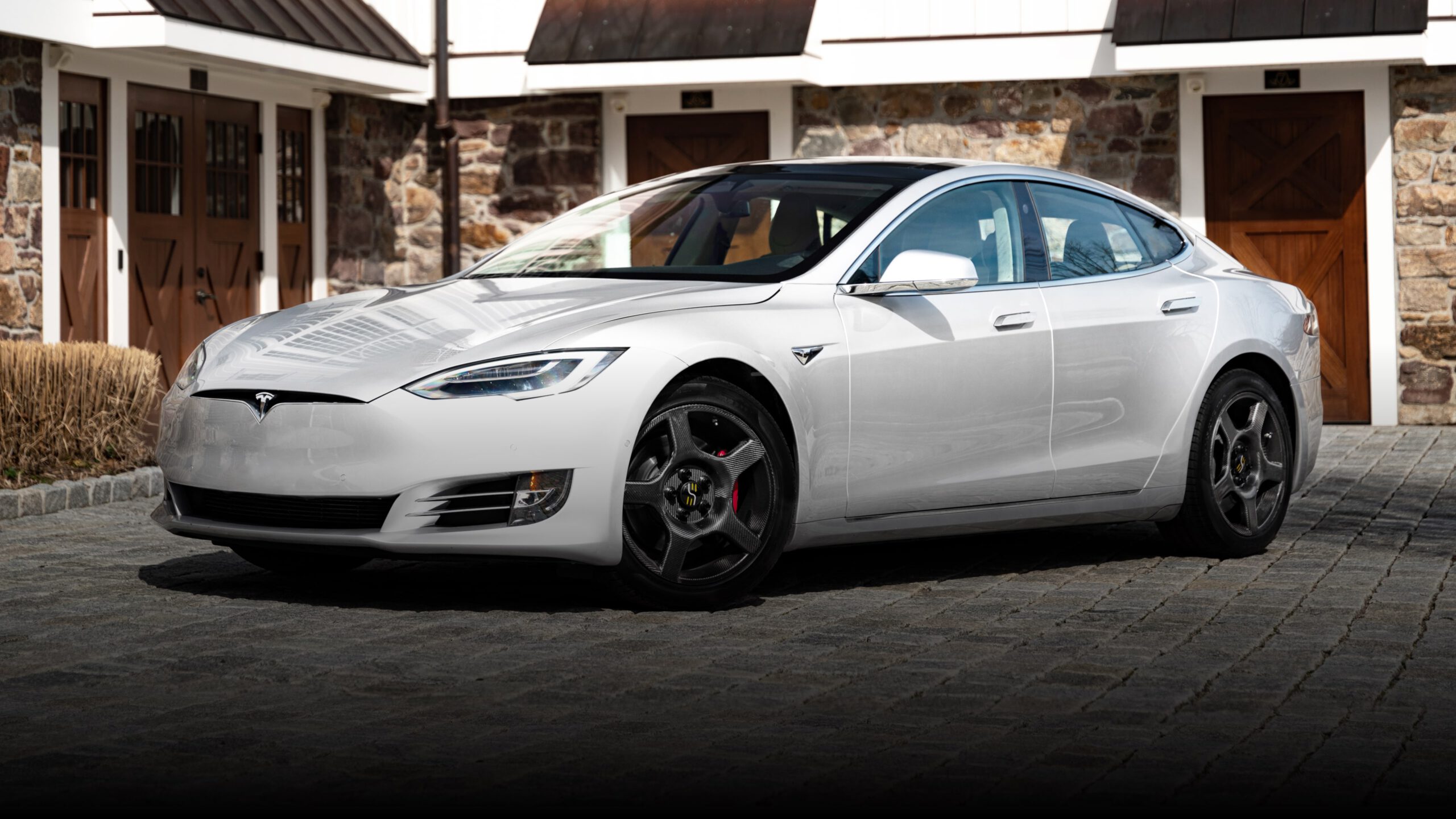 a silver Tesla with carbon fiber wheels