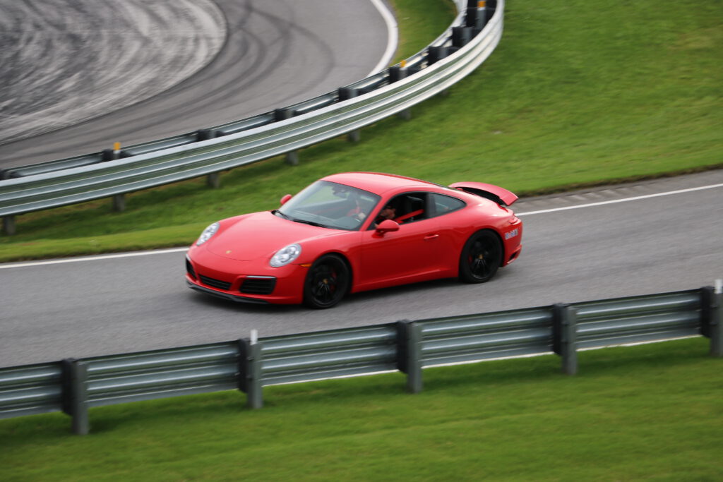 the red Porche with carbon fiber wheels driving on a track